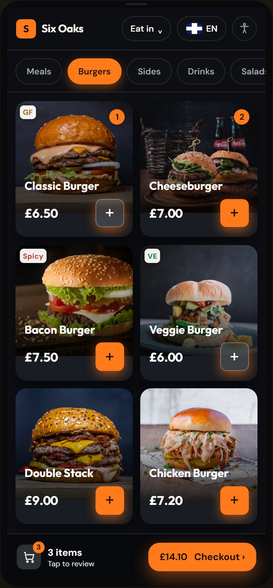 The same kiosk browse screen in the dark late-night preset: dark chrome, amber accent colour, glowing image-led product cards and an amber checkout bar