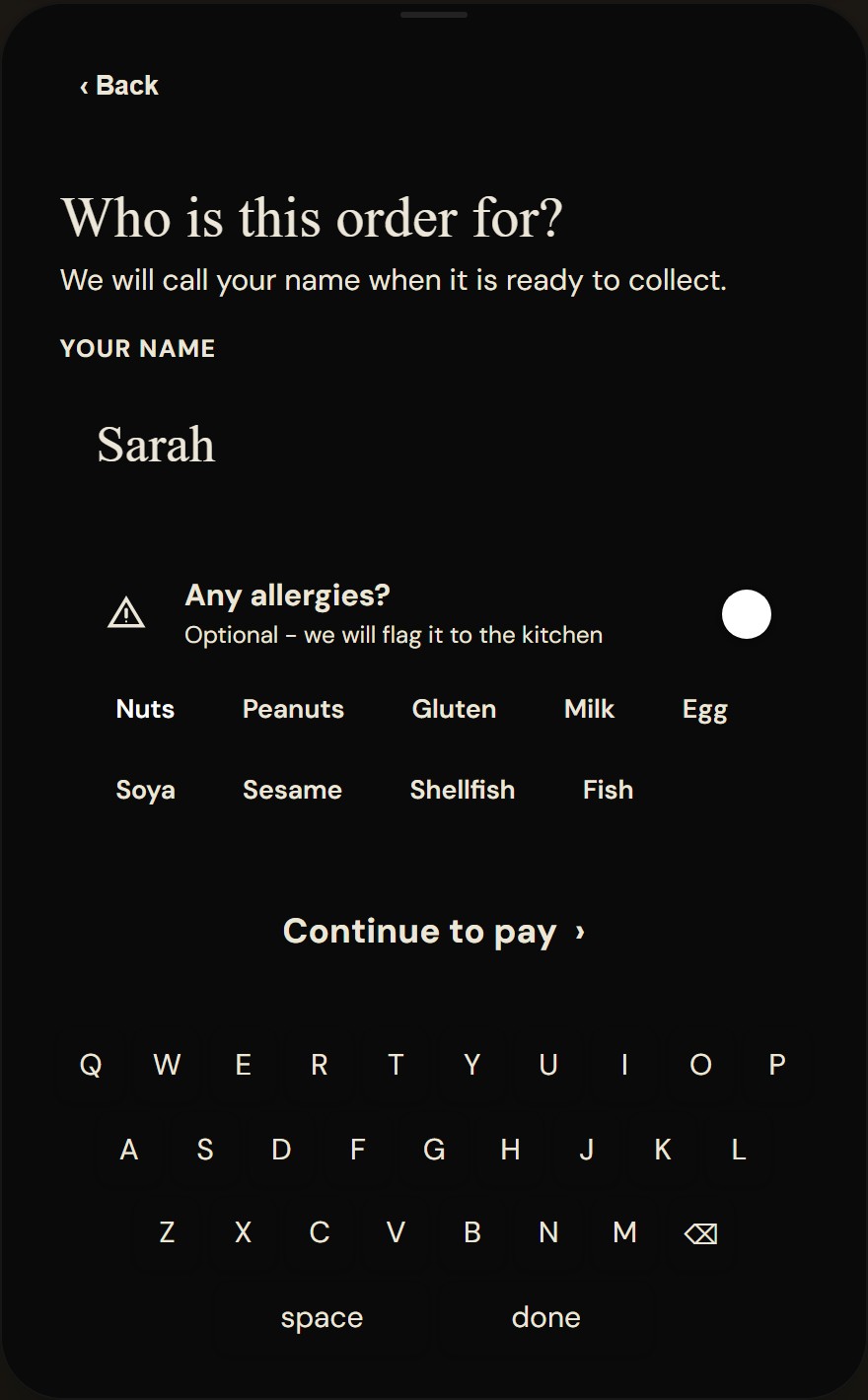 Kiosk pre-checkout screen asking who the order is for, with a name field, an optional allergy toggle with allergen chips, a continue to pay button and an on-screen keyboard